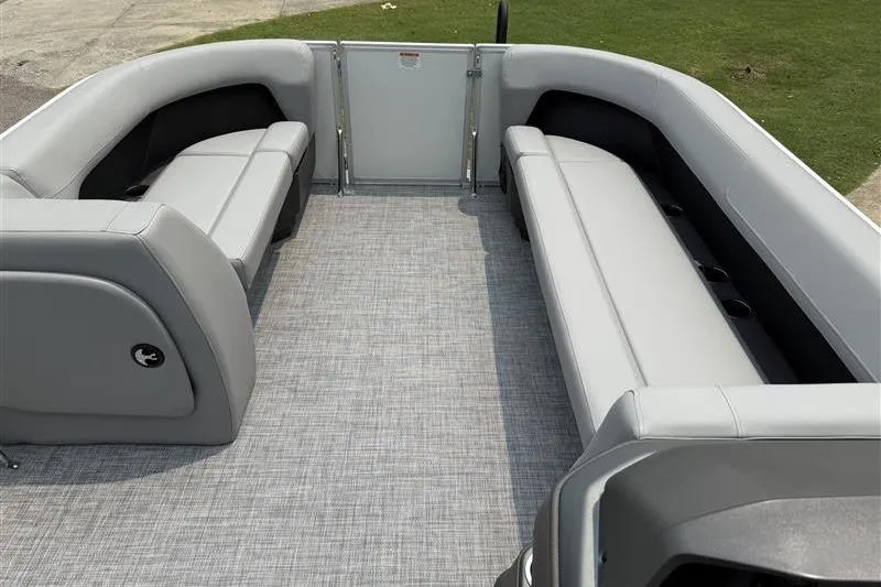 Slide: The Image of 2026 Sun Tracker Party Barge 18 DLX interior with gray seating and flooring. - 9