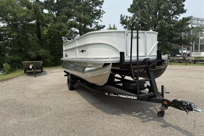Slide: The Image of 2026 Sun Tracker Party Barge 18 DLX pontoon boat on trailer in outdoor setting. - 6
