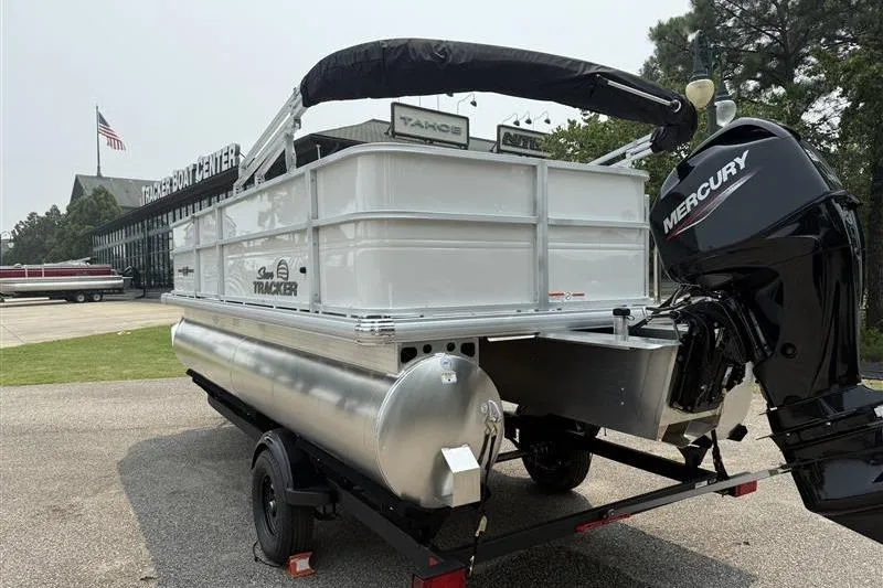 Slide: The Image of 2026 Sun Tracker Party Barge 18 DLX pontoon boat with Mercury engine on trailer. - 5