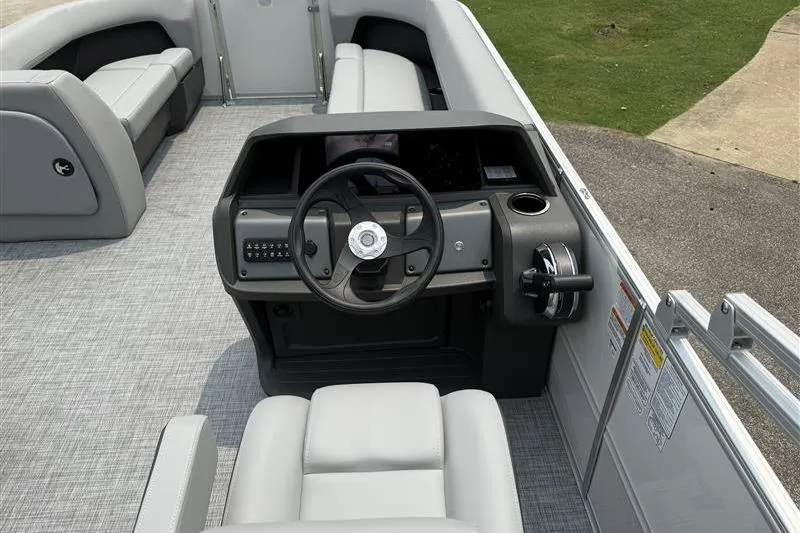Slide: The Image of 2026 Sun Tracker Party Barge 18 DLX interior with steering console and seating. - 11
