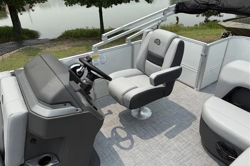 Slide: The Image of 2026 Sun Tracker Party Barge 18 DLX interior with captain's chair and steering console. - 10