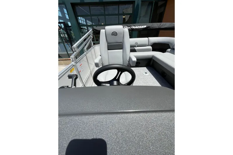 Slide: The Image of 2026 Sun Tracker Party Barge 20 DLX interior with steering wheel and seating. - 7