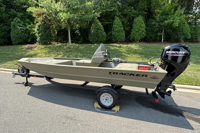 Slide: The Image of 2026 Tracker Grizzly 1648 SC boat on trailer with Mercury outboard motor. - 4
