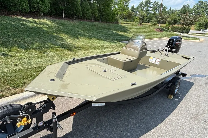 Slide: The Image of 2026 Tracker Grizzly 1648 SC boat on trailer, parked outdoors. - 3