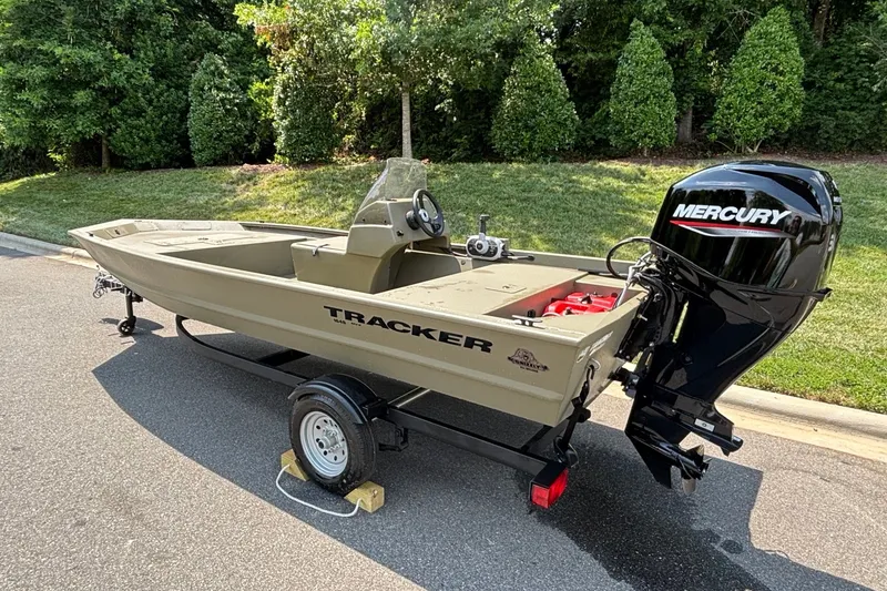 Slide: The Image of 2026 Tracker Grizzly 1648 SC boat with Mercury engine on trailer. - 5