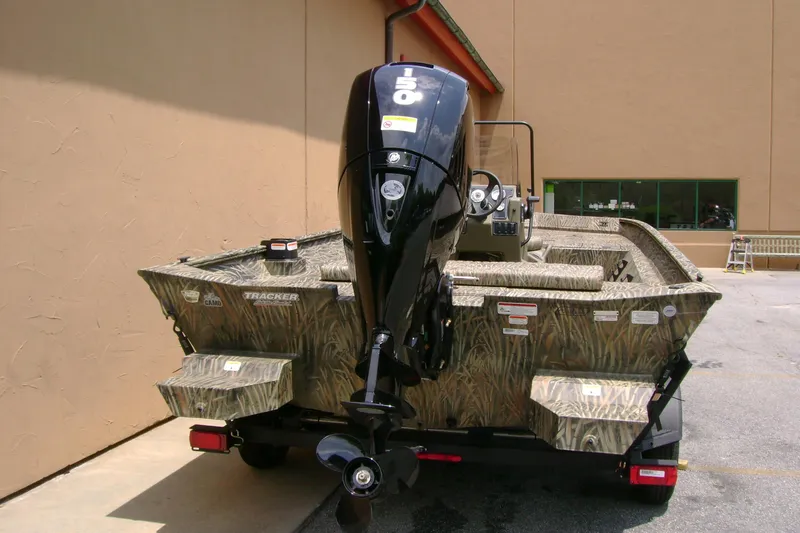 Slide: The Image of 2026 Tracker Grizzly 2072 CC boat with camouflage design and powerful outboard motor. - 3