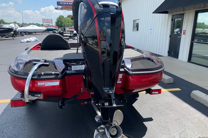 Slide: The Image of Red Nitro Z17 boat, 2026 model, parked outside a building with a powerful outboard motor. - 3