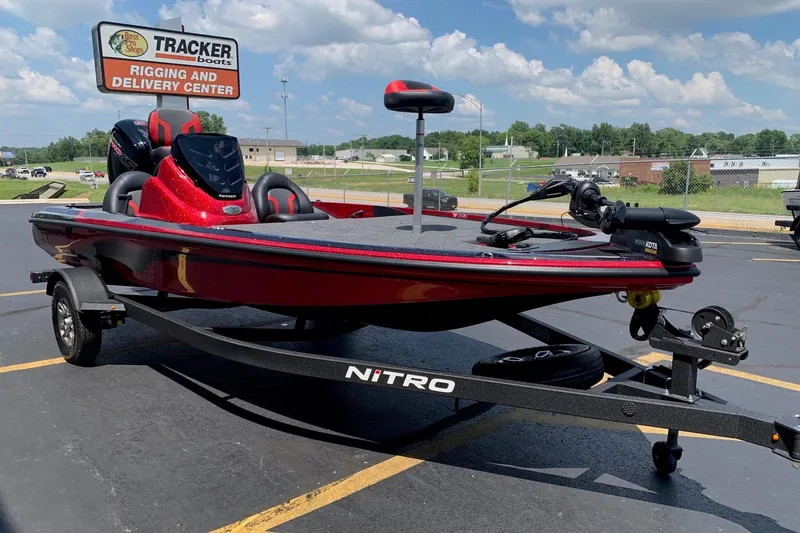Slide: The Image of 2026 Nitro Z17 boat in red, parked at Tracker Boats Rigging and Delivery Center. - 2