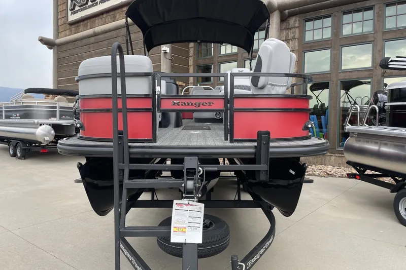 Slide: The Image of 2026 Ranger 223FC pontoon boat displayed on trailer at dealership. - 4