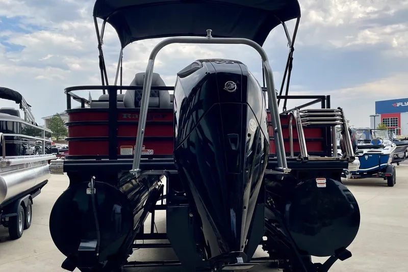 Slide: The Image of 2026 Ranger 223FC pontoon boat with powerful outboard motor, docked under cloudy sky. - 5