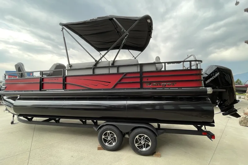 Slide: The Image of 2026 Ranger 223FC pontoon boat with canopy, red and black design, on trailer. - 1