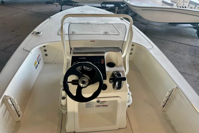 Slide: The Image of 2026 Mako 18 Pro Skiff boat interior with steering console and controls. - 8