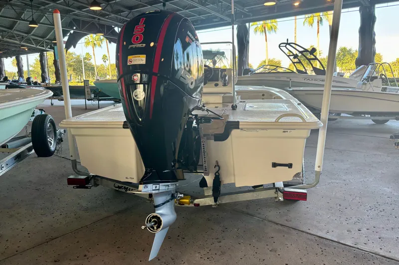 Slide: The Image of 2026 Mako 18 Pro Skiff boat with powerful 150 HP engine, displayed indoors. - 4