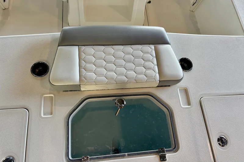 Slide: The Image of Interior of 2026 Mako 18 Pro Skiff boat with cushioned seating and storage compartments. - 11