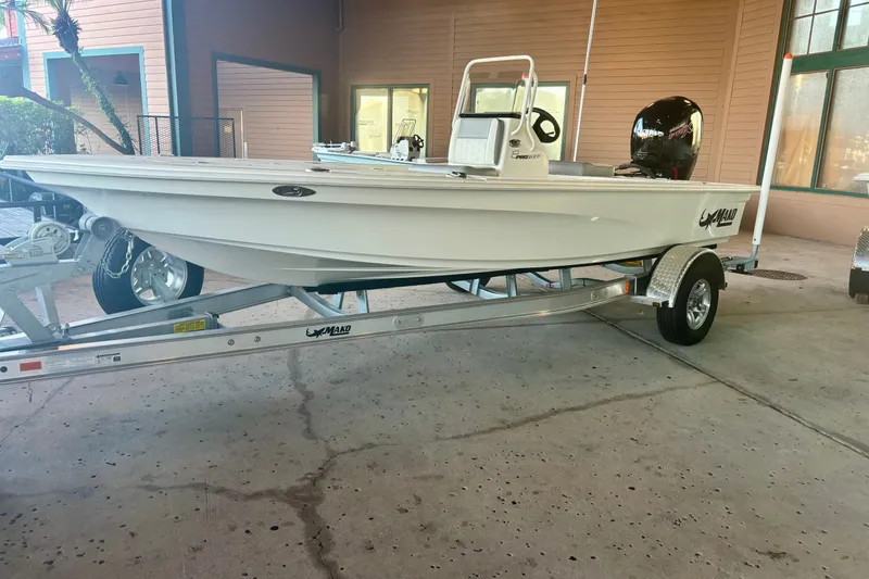 The Image of 2026 Mako 18 Pro Skiff on trailer, parked indoors, showcasing sleek design and modern features. - 0