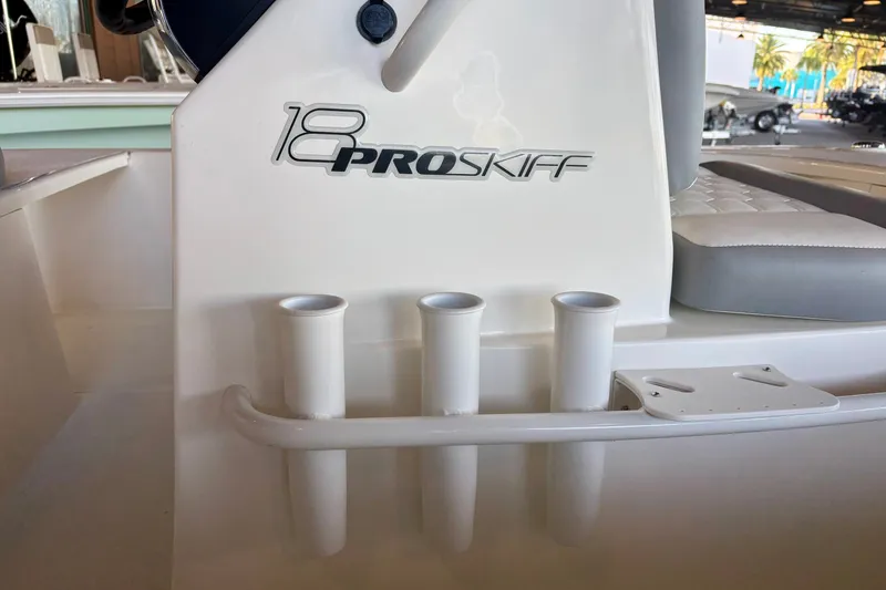 Slide: The Image of 2026 Mako 18 Pro Skiff boat interior with rod holders and seating. - 7