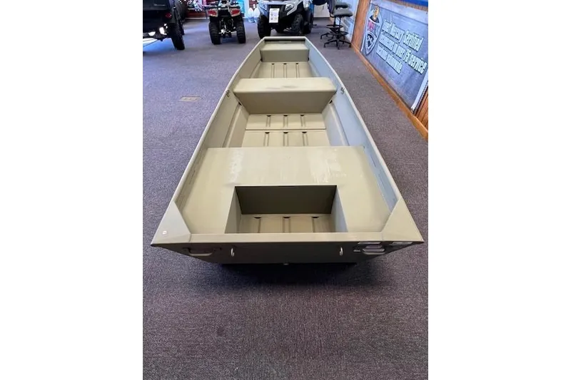 Slide: The Image of 2026 Tracker Grizzly 14 Jon boat displayed indoors, showcasing its spacious interior design. - 3