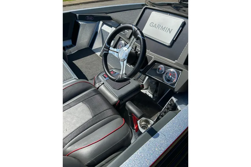 Slide: The Image of 2025 Ranger Z518 Cup-Equipped boat interior with Garmin display and sleek steering wheel. - 5