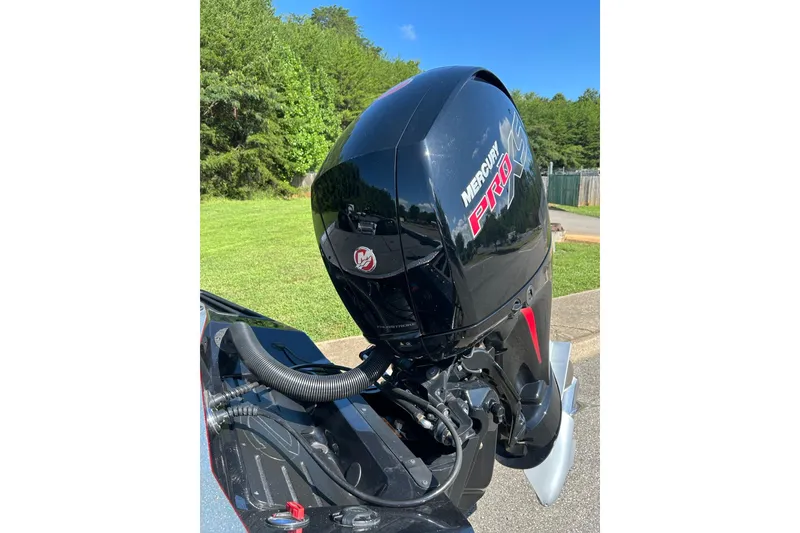 Slide: The Image of 2025 Ranger Z518 Cup-Equipped boat with Mercury Pro XS outboard motor in a sunny outdoor setting. - 2