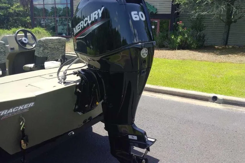 Slide: The Image of 2026 Tracker Grizzly 1754 SC boat with Mercury 60 outboard motor on a sunny day. - 7
