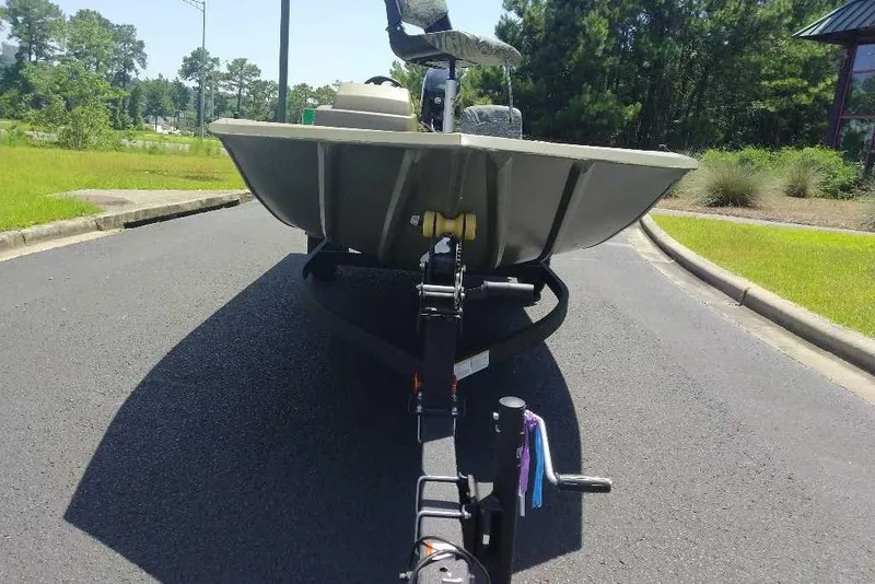 Slide: The Image of 2026 Tracker Grizzly 1754 SC boat on trailer, parked on a sunny road. - 9