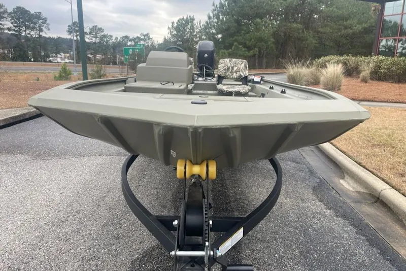Slide: The Image of 2026 Tracker Grizzly 1754 SC boat on trailer, parked outdoors, showcasing its sturdy design. - 2