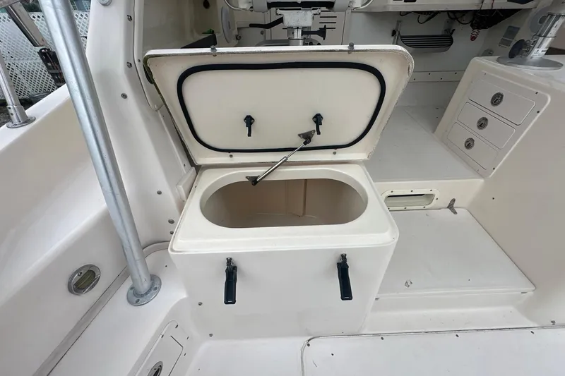 Slide: The Image of 2006 Grady-White Marlin 300 boat interior with open storage compartment. - 10