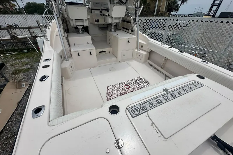Slide: The Image of 2006 Grady-White Marlin 300 boat interior with seating and fishing equipment. - 13