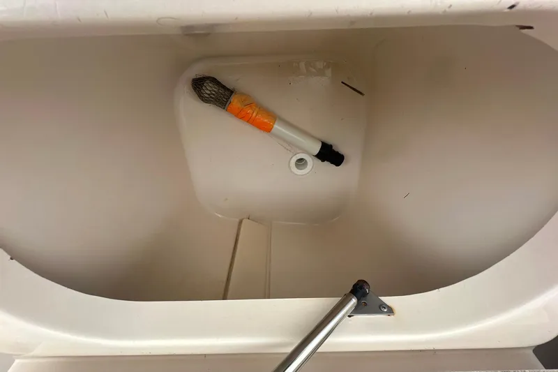 Slide: The Image of Storage compartment of a 2006 Grady-White Marlin 300 boat with a brush inside. - 15