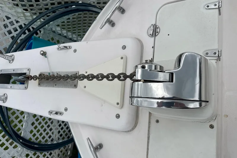 Slide: The Image of Anchor chain and windlass on a 2006 Grady-White Marlin 300 boat deck. - 2
