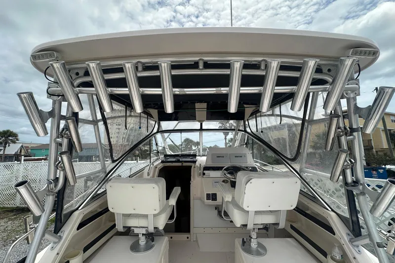 Slide: The Image of 2006 Grady-White Marlin 300 boat interior with helm and rod holders. - 8