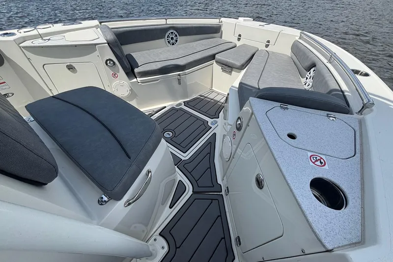 Slide: The Image of 2021 Stingray 216 CC boat interior with cushioned seating and storage compartments. - 6