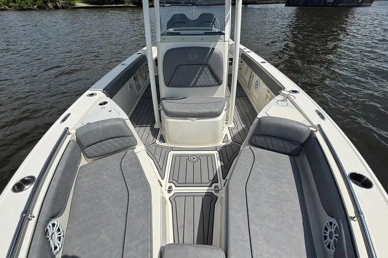 Slide: The Image of 2021 Stingray 216 CC boat interior with gray seating and sleek design on the water. - 8