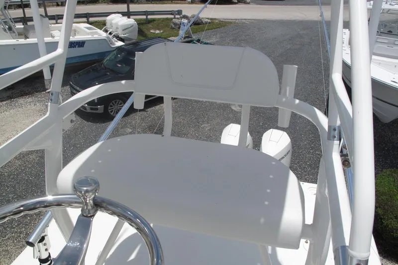 Slide: The Image of 2022 SeaVee 322Z boat helm station with white seating and steering wheel. - 28