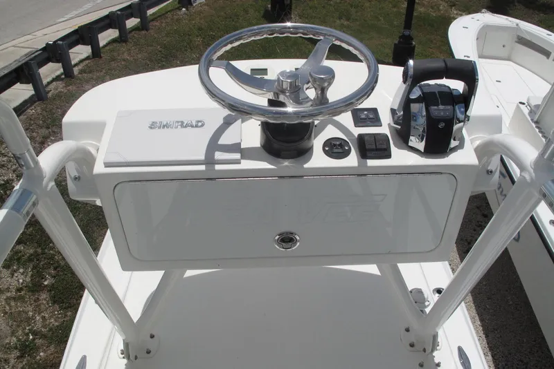 Slide: The Image of 2022 SeaVee 322Z boat helm with steering wheel and Simrad navigation system. - 25
