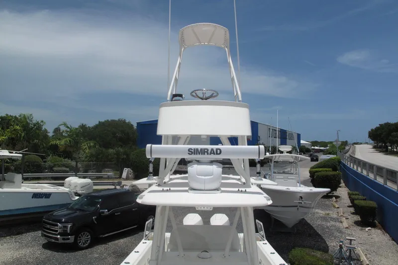 Slide: The Image of 2022 SeaVee 322Z boat with Simrad equipment, parked near a road and dealership. - 11