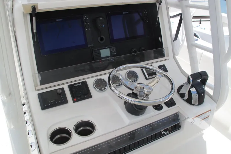 Slide: The Image of 2022 SeaVee 322Z boat dashboard with steering wheel and navigation controls. - 16