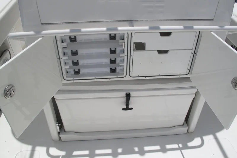 Slide: The Image of 2022 SeaVee 322Z boat storage compartments with open doors and organized tackle boxes. - 20