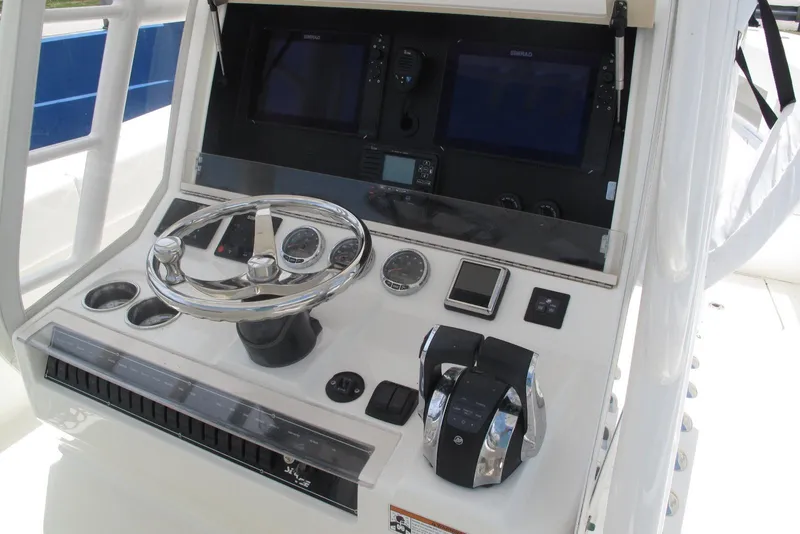 Slide: The Image of 2022 SeaVee 322Z boat console with steering wheel, controls, and navigation screens. - 15
