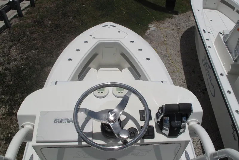 Slide: The Image of 2022 SeaVee 322Z boat helm with steering wheel and controls. - 24