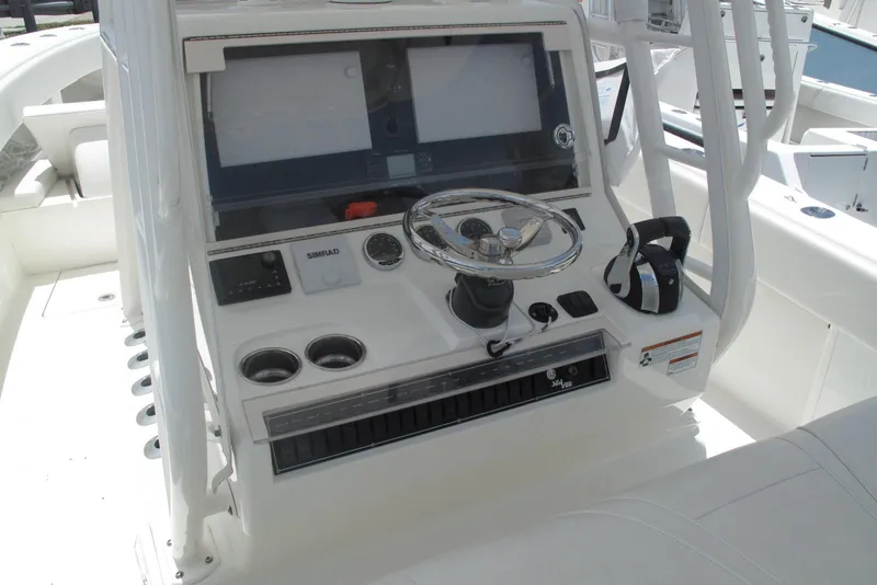 Slide: The Image of 2022 SeaVee 322Z boat console with steering wheel, dual screens, and control panel. - 18