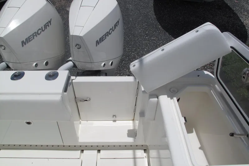 Slide: The Image of 2022 SeaVee 322Z boat with dual Mercury engines and open storage compartment. - 22
