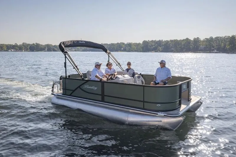 Slide: The Image of 2026 Bentley Pontoons LE 180 CR cruising on a sunny lake with passengers. - 2