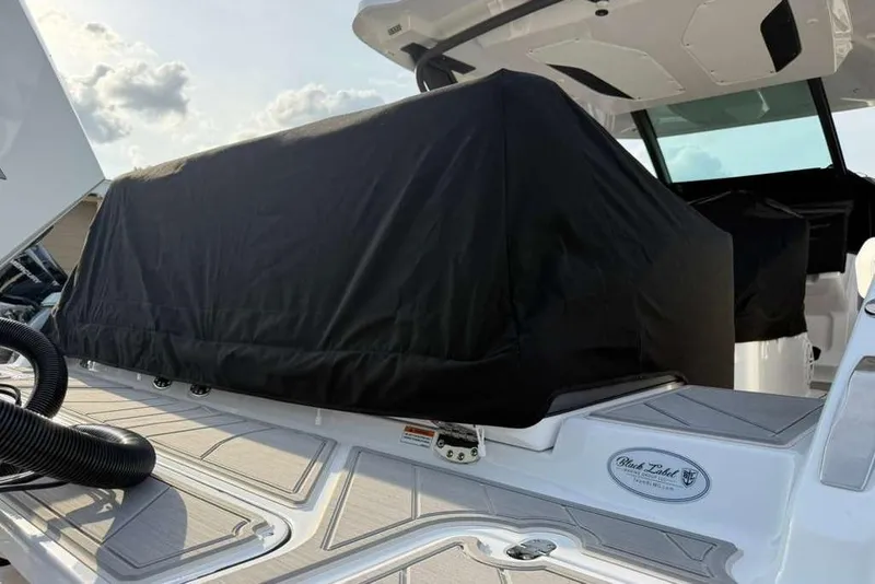 Slide: The Image of 2026 Monterey Elite 30 OB boat with covered seating area on deck. - 87