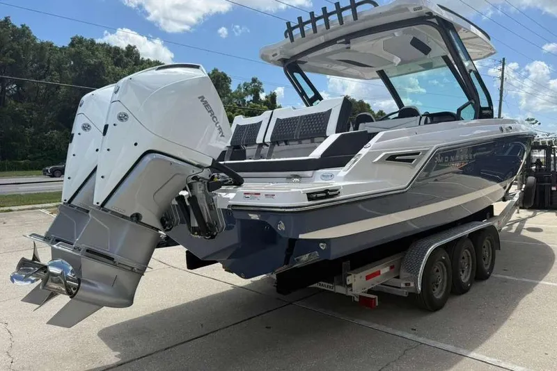 Slide: The Image of 2026 Monterey Elite 30 OB boat with dual Mercury outboard engines on a trailer. - 25