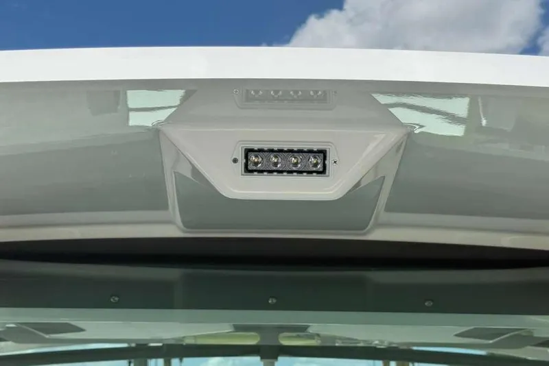 Slide: The Image of LED light fixture on 2026 Monterey Elite 30 OB boat against blue sky. - 81