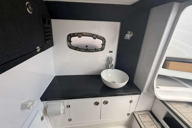 Slide: The Image of Modern bathroom interior of 2026 Monterey Elite 30 OB boat, featuring sleek sink and cabinetry. - 34