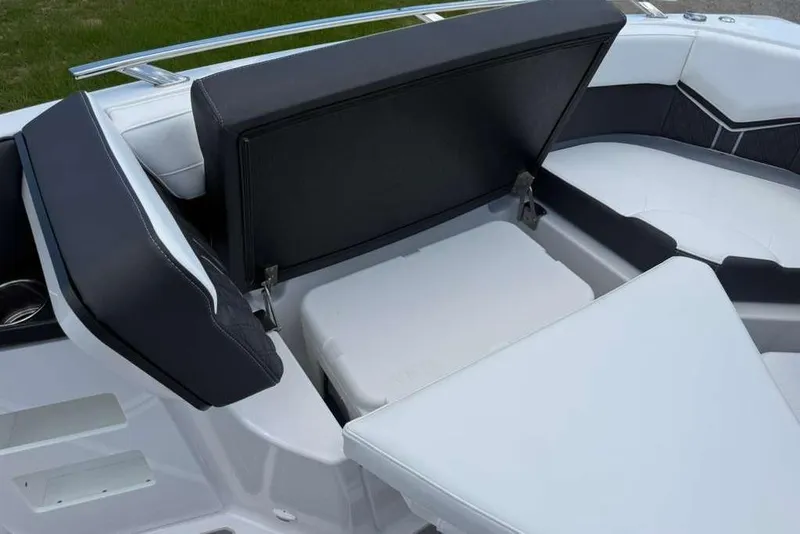 Slide: The Image of 2026 Monterey Elite 30 OB boat interior with open storage compartment and cushioned seating. - 42