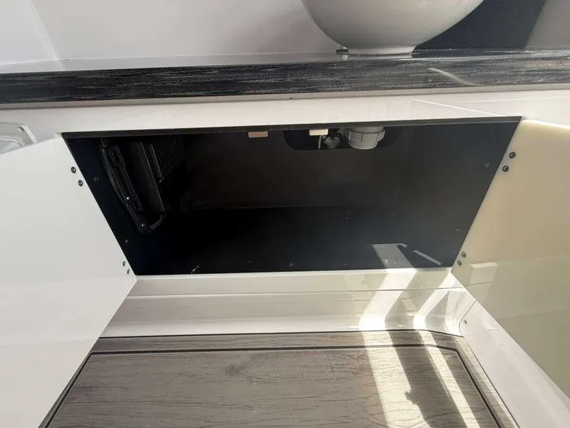 Slide: The Image of Open storage space in a boat with wood flooring and countertop. - 14