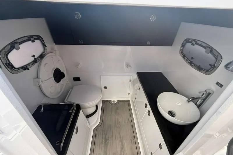 Slide: The Image of Modern bathroom interior of 2026 Monterey Elite 30 OB boat, featuring sleek fixtures and wood flooring. - 36